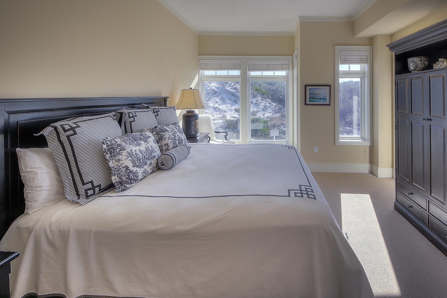 99 Compass Point Way South, Unit 208 Watersound, FL 32461 - Photo 3 of 17 a bed sitting in a bedroom next to a window