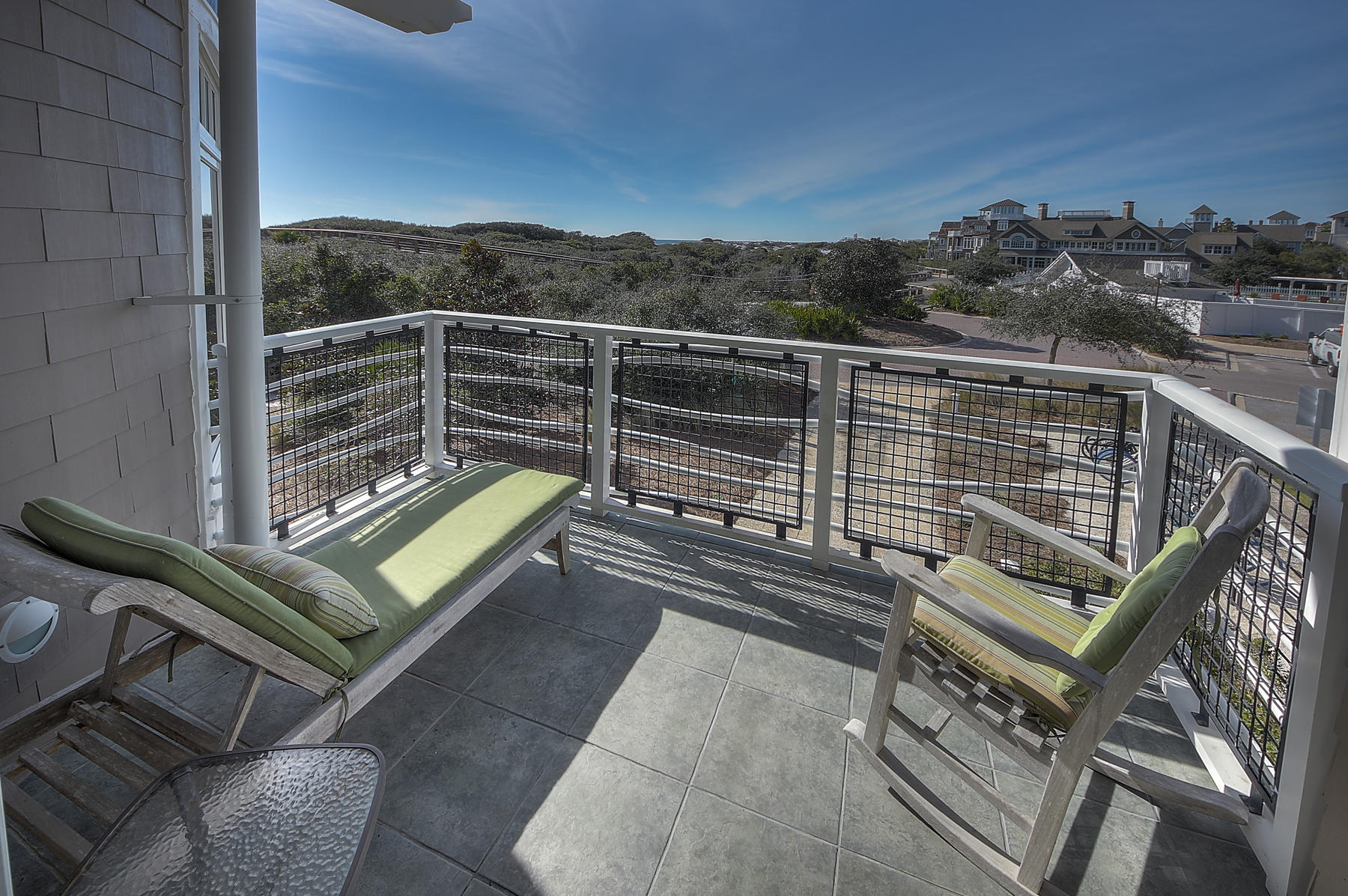 99 Compass Point Way South, Unit 208 Watersound, FL 32461 - Photo 7 of 17 a view of a balcony with a chair and wooden floor