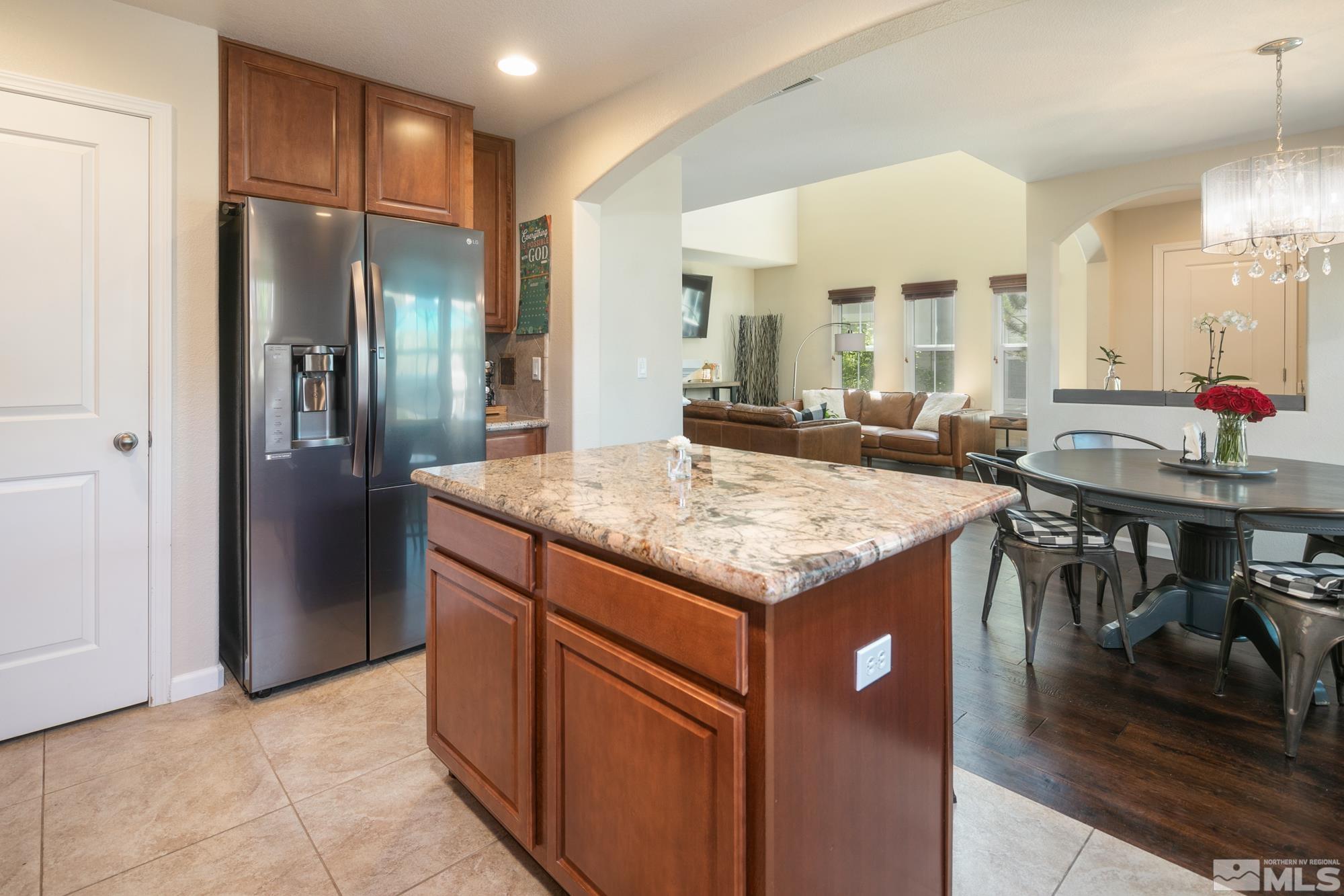 7665 Pebblestone Way Reno, NV 89523 - Photo 11 of 34 a kitchen with stainless steel appliances granite countertop wooden cabinets and sink