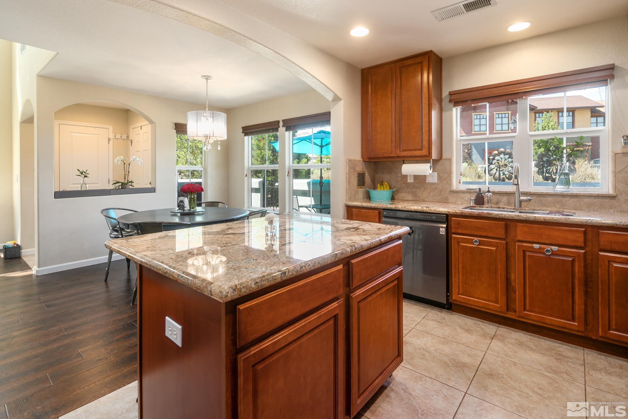 7665 Pebblestone Way Reno, NV 89523 - Photo 13 of 34 a kitchen with granite countertop a sink and cabinets