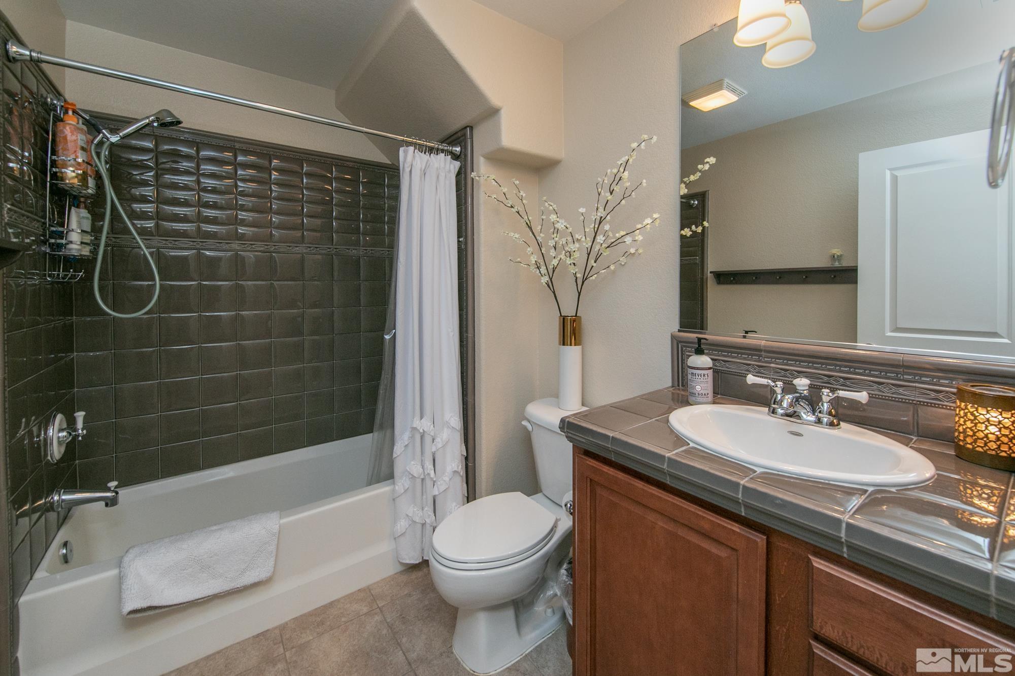 7665 Pebblestone Way Reno, NV 89523 - Photo 16 of 34 a bathroom with a sink toilet and shower