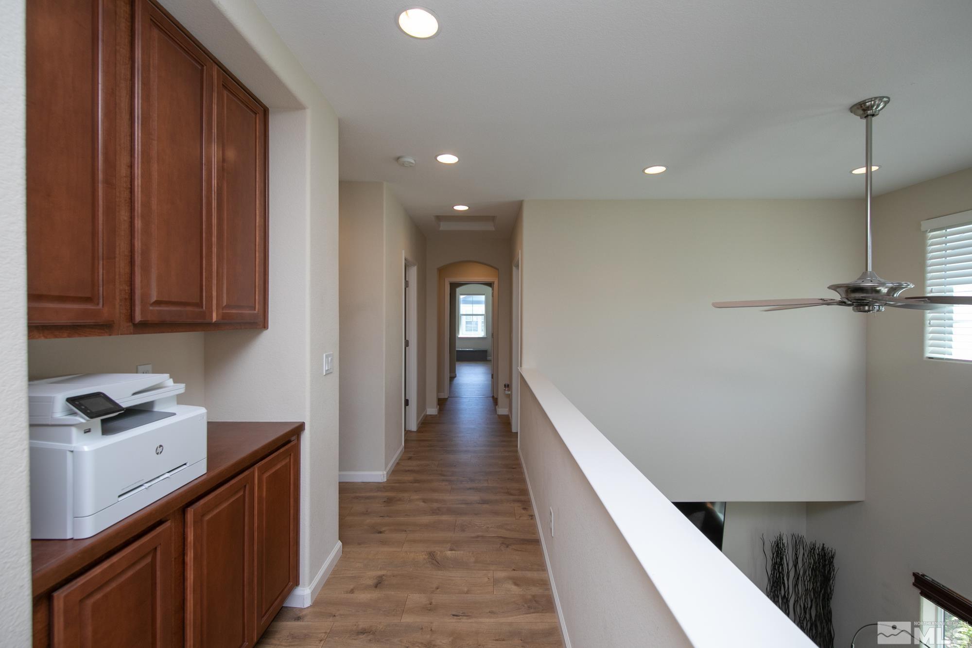 7665 Pebblestone Way Reno, NV 89523 - Photo 18 of 34 a hallway with wooden floor cabinets and entryway