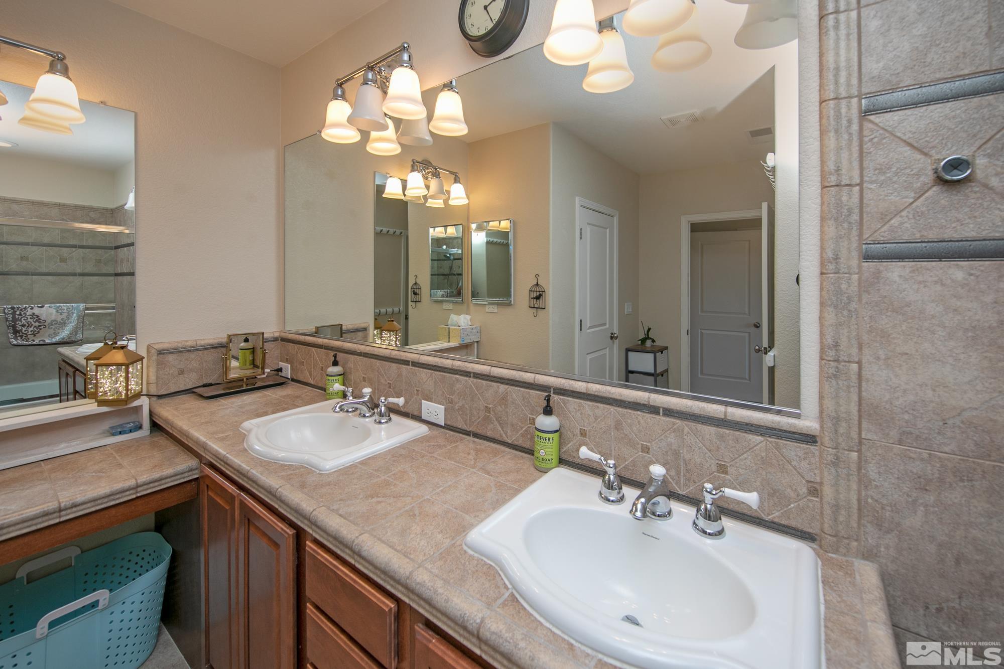 7665 Pebblestone Way Reno, NV 89523 - Photo 22 of 34 a bathroom with a sink double vanity and a mirror