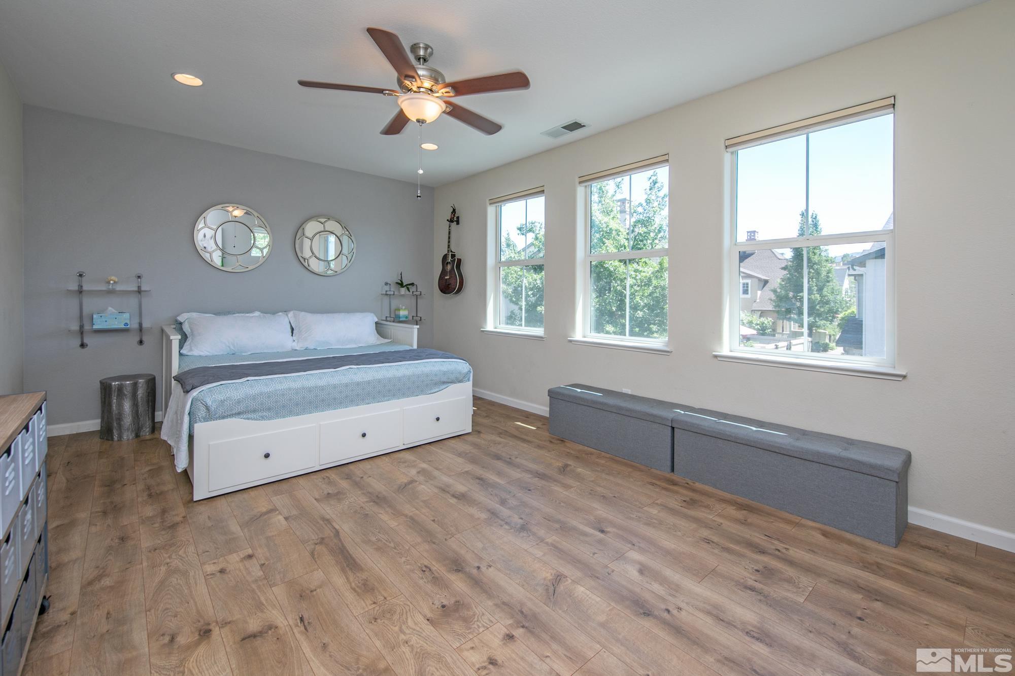 7665 Pebblestone Way Reno, NV 89523 - Photo 24 of 34 a spacious bedroom with a large bed and a large window