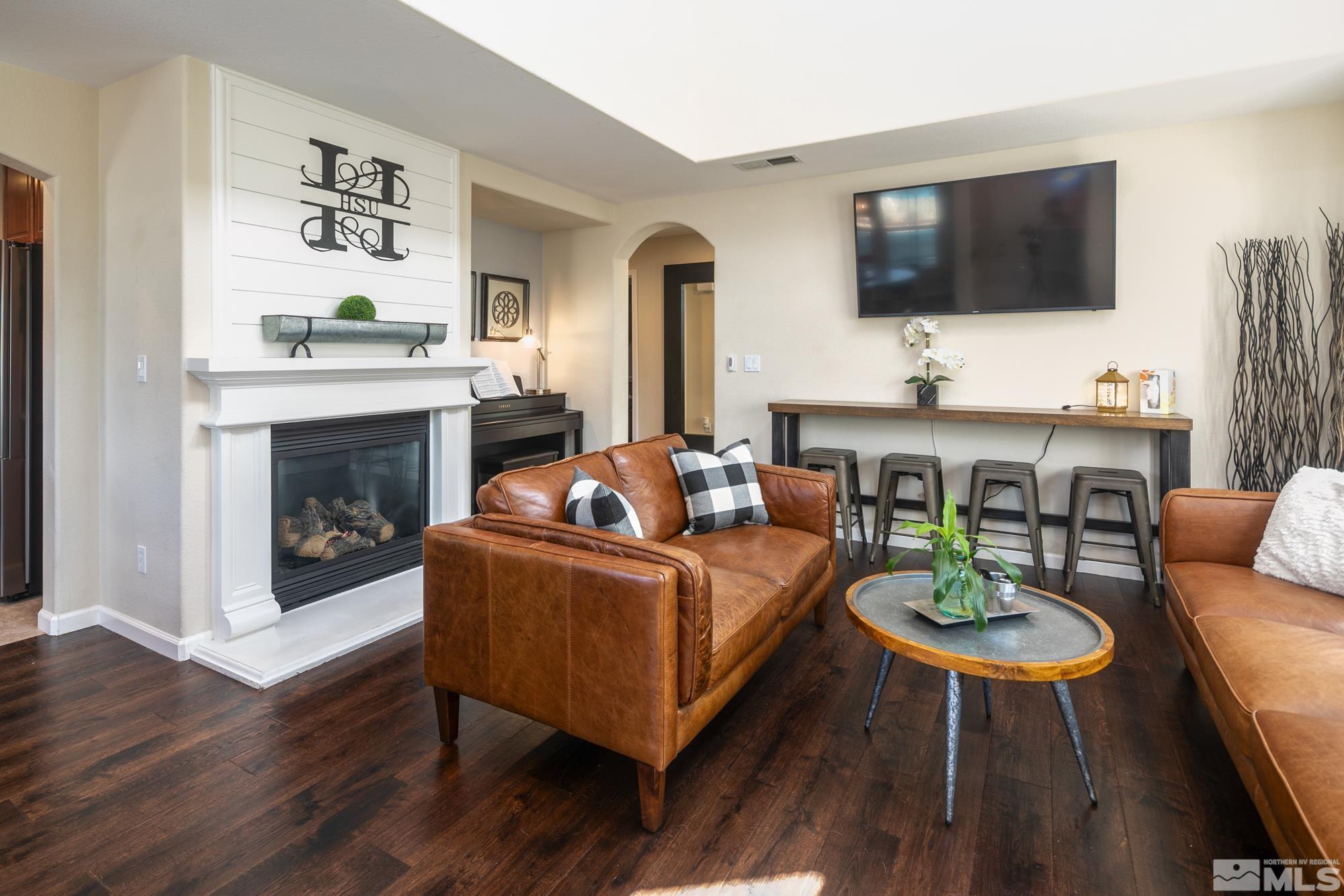 7665 Pebblestone Way Reno, NV 89523 - Photo 5 of 34 a living room with fireplace furniture and a flat screen tv