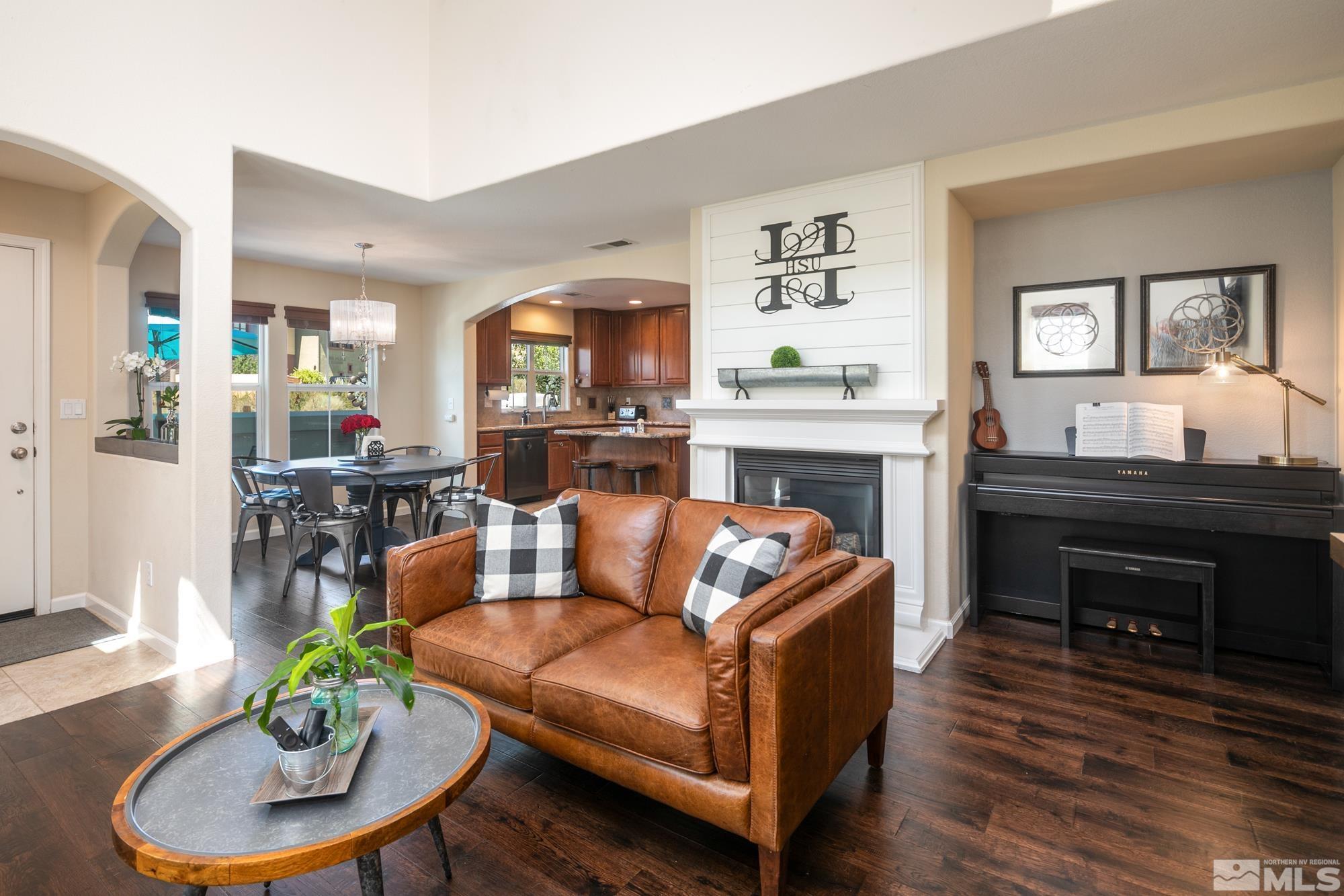 7665 Pebblestone Way Reno, NV 89523 - Photo 6 of 34 a living room with furniture and a fireplace