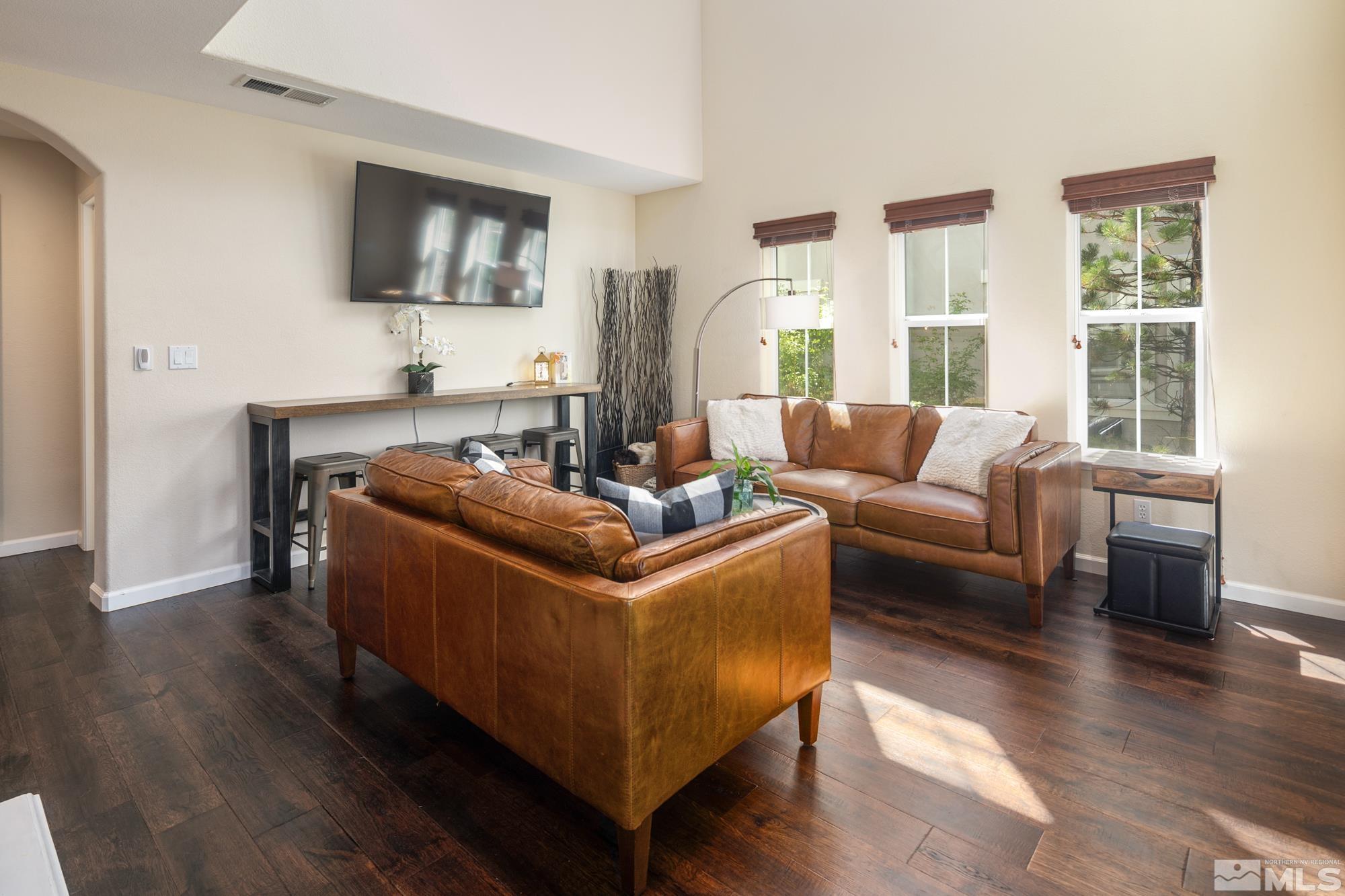 7665 Pebblestone Way Reno, NV 89523 - Photo 7 of 34 a living room with furniture and a flat screen tv