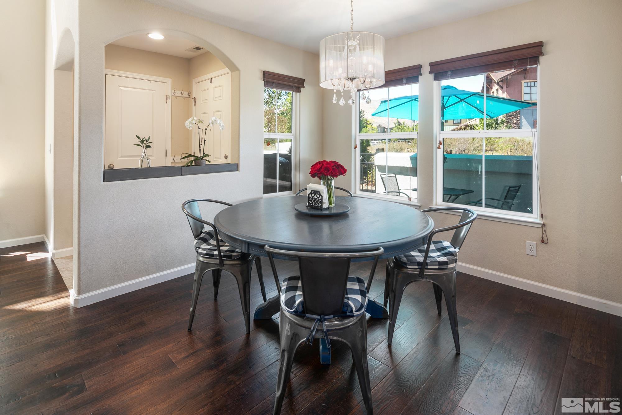 7665 Pebblestone Way Reno, NV 89523 - Photo 8 of 34 a view of a dining room with furniture wooden floor and chandelier