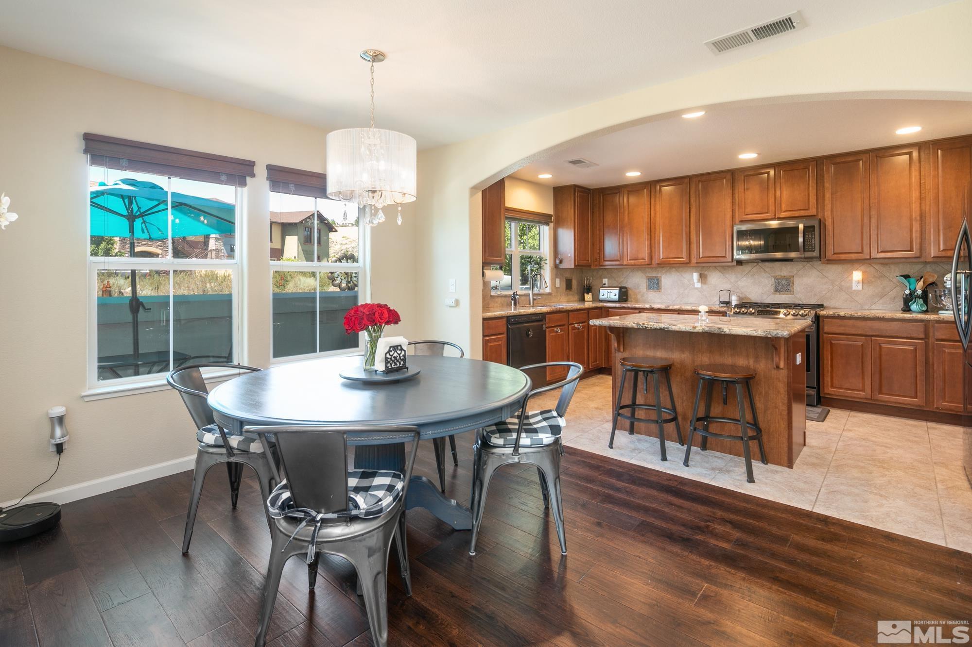 7665 Pebblestone Way Reno, NV 89523 - Photo 9 of 34 a view of a dining room with furniture window and wooden floor