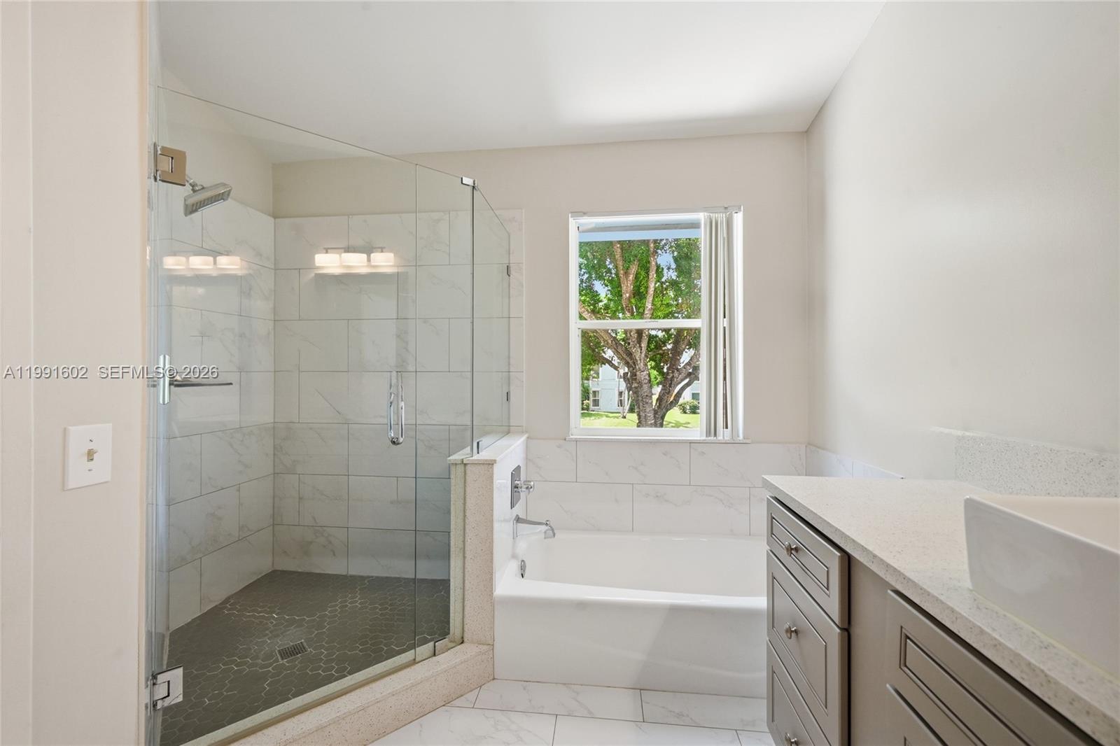 6215 Old Court Road, Unit 505 Boca Raton, FL 33433 - Photo 28 of 36 a bathroom with a shower and a bathtub