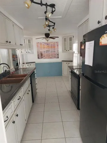 a view of a living room and kitchen