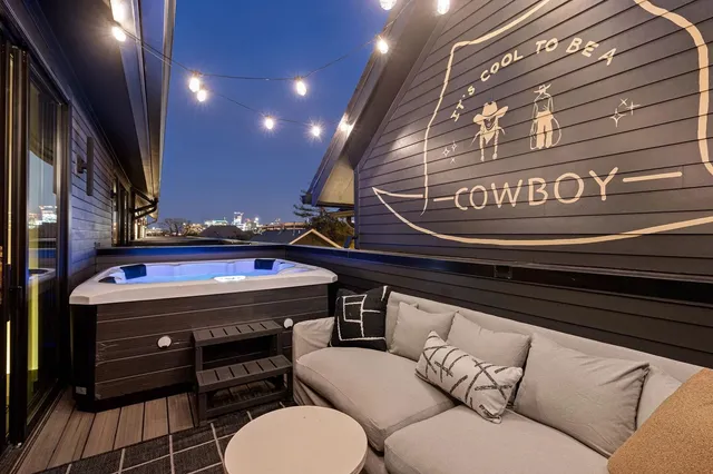 a living room with furniture and a floor to ceiling window