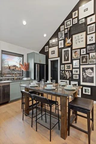 a kitchen with a table chairs sink and cabinets