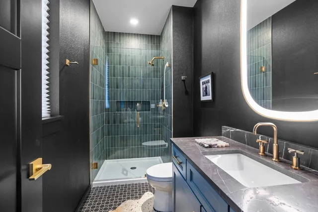 a bedroom with a large bed and a potted plant