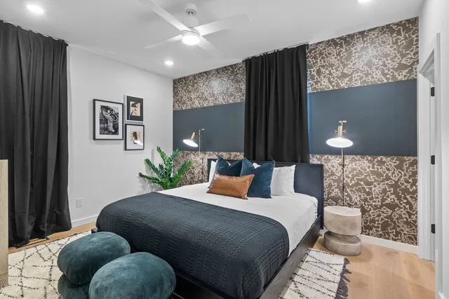 a bedroom with bed and a potted plant