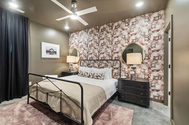 a bedroom with a bed and a painting on the wall