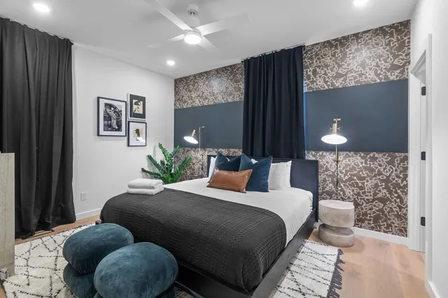 a living room with furniture and a floor to ceiling window