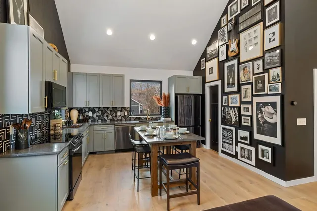 a kitchen with a stove a sink and a microwave