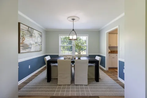 a kitchen with sink a refrigerator and a view of living room