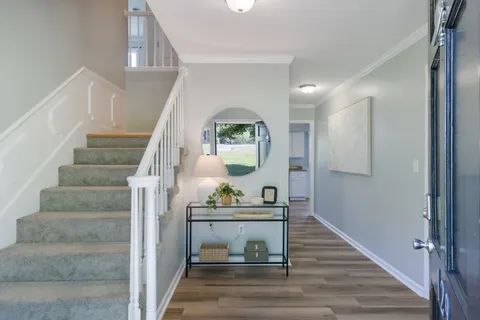 a view of entryway and hall with wooden floor