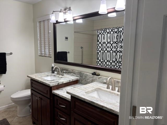 7310 Cook Road Foley, AL 36535 - Photo 14 of 14 Full bathroom with two vanities, a shower with shower curtain, and light tile patterned flooring