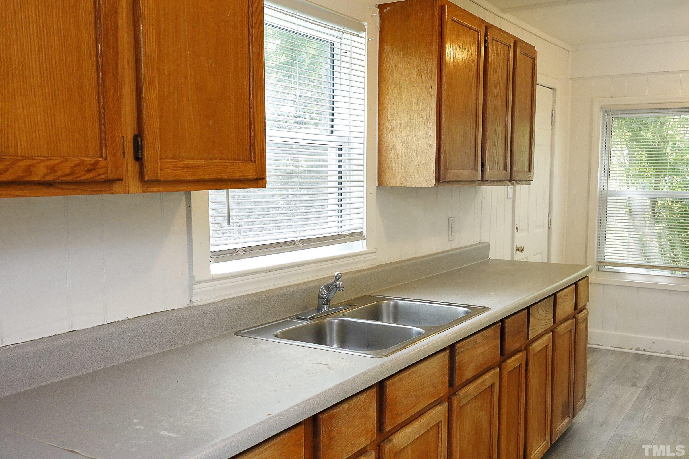 2522 Rochelle Street Durham, NC 27703 - Photo 17 of 28 a kitchen with stainless steel appliances a sink window and cabinets