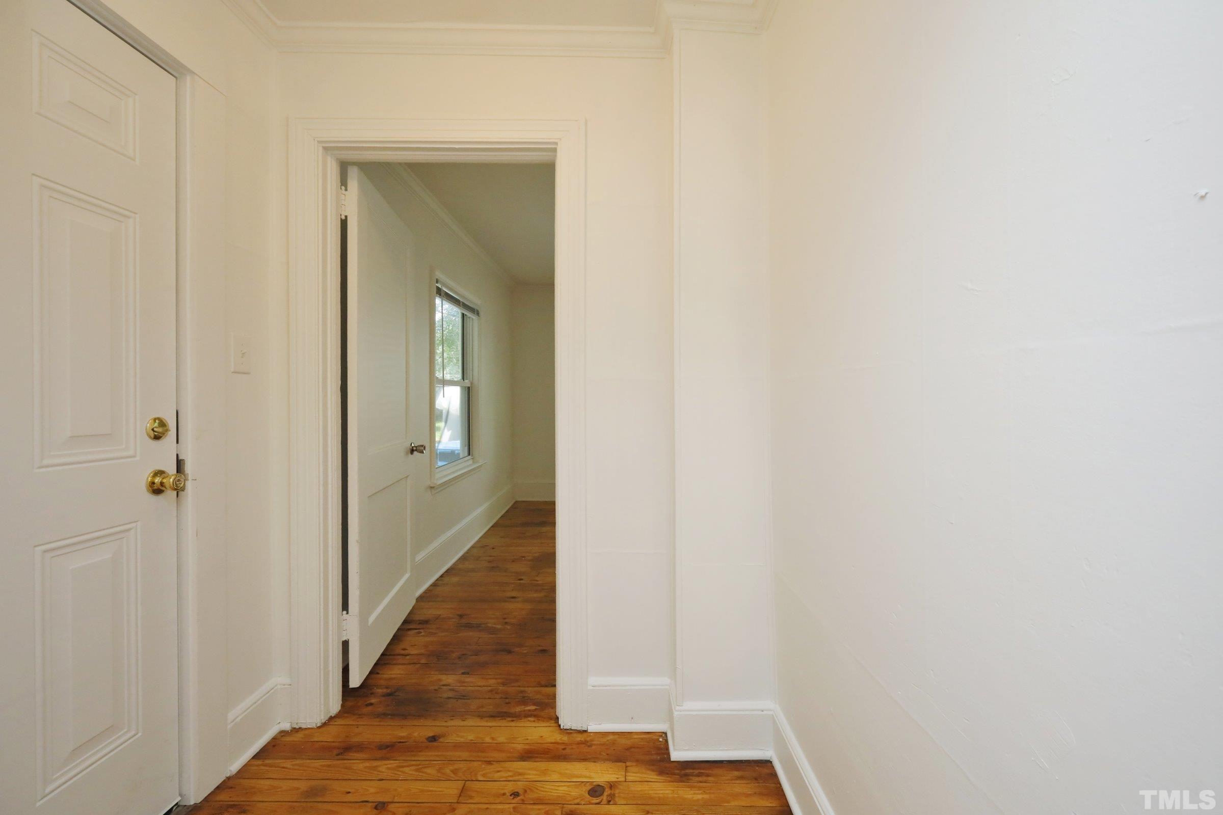 2522 Rochelle Street Durham, NC 27703 - Photo 8 of 28 a view of a hallway with wooden floor
