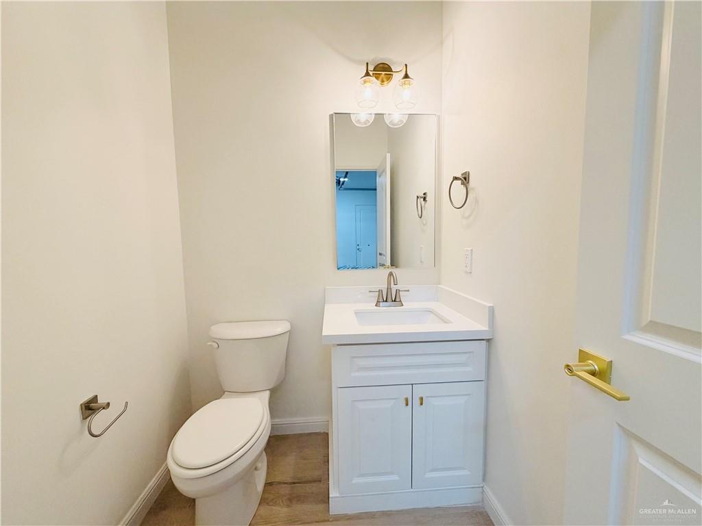 807 Ramirez Street Mission, TX 78573 - Photo 13 of 16 White vanity with a single basin sink, white countertop, and brushed nickel faucet