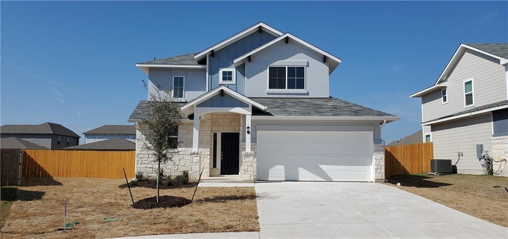 212 Lake Placid Run Elgin, TX 78621 - Photo 1 of 1 Contemporary two-story residence featuring a light gray exterior with stone accents and board-and-batten siding