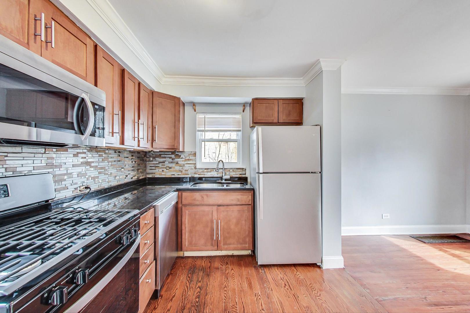402 North Main Street Mount Prospect, IL 60056 - Photo 9 of 19 a kitchen with granite countertop a refrigerator stove top oven and sink