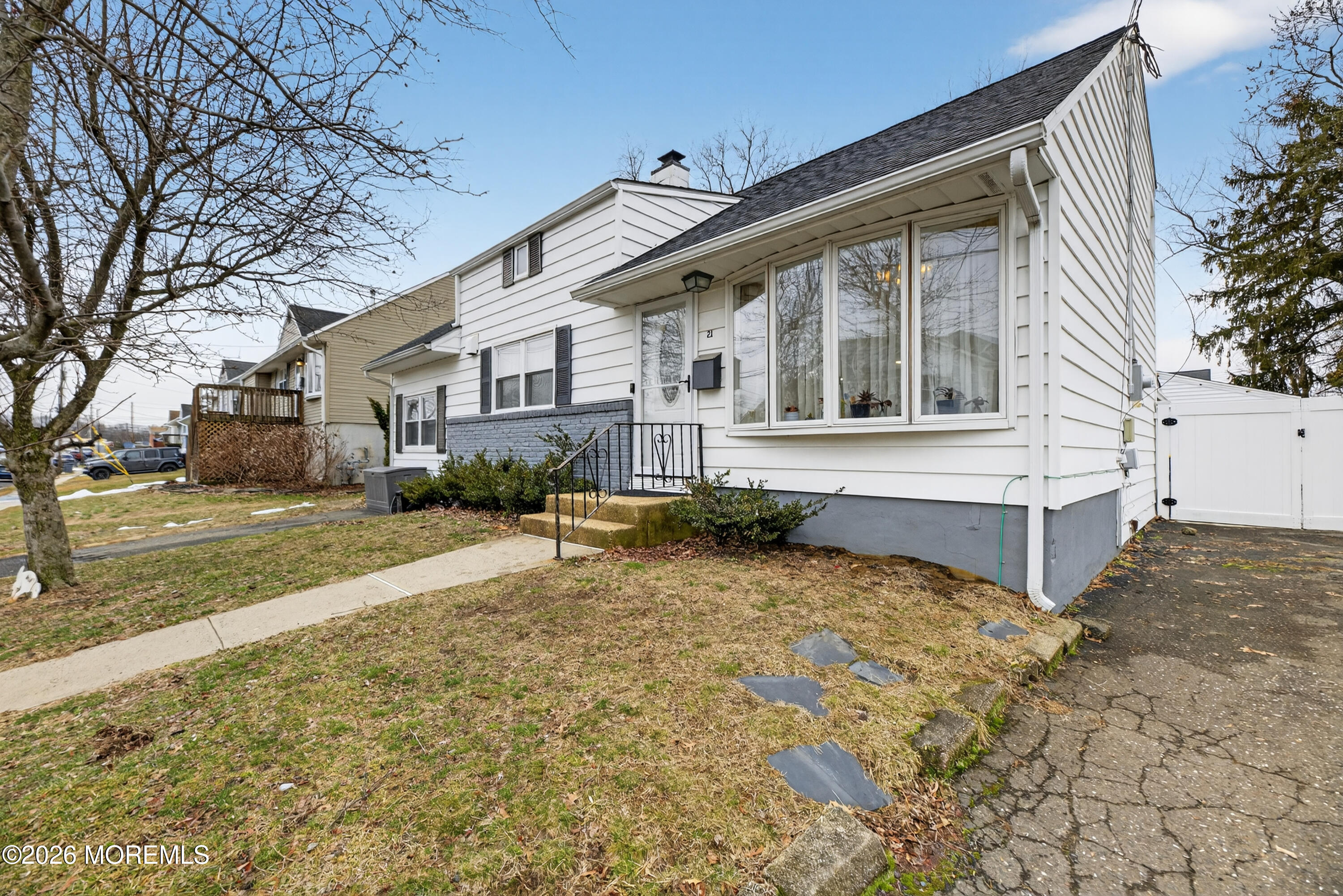21 Anderson Street Union Beach, NJ 07735 - Photo 1 of 40 a view of a white house with a yard covered in snow