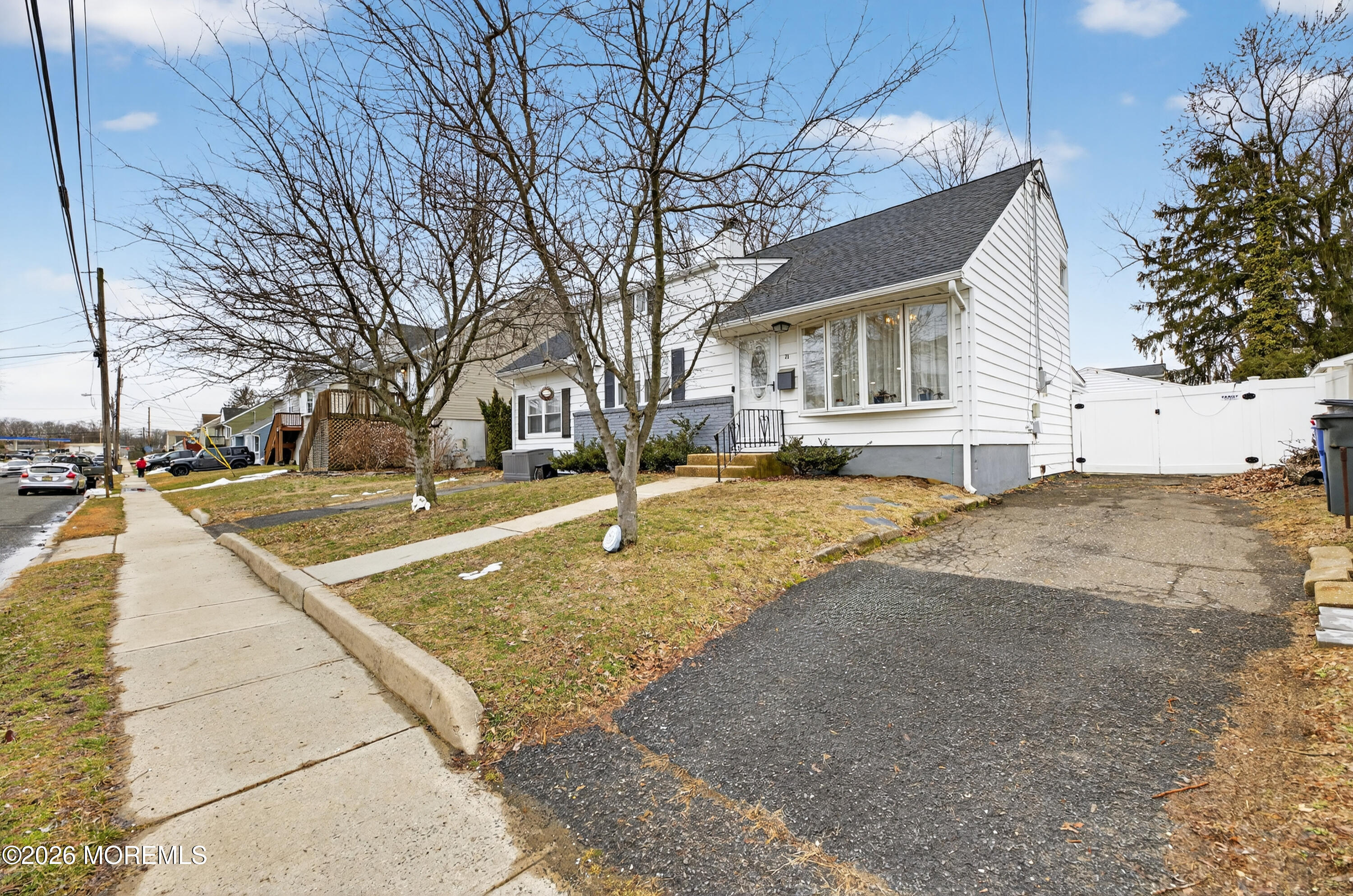 21 Anderson Street Union Beach, NJ 07735 - Photo 3 of 40 a view of a white house with a yard covered in snow