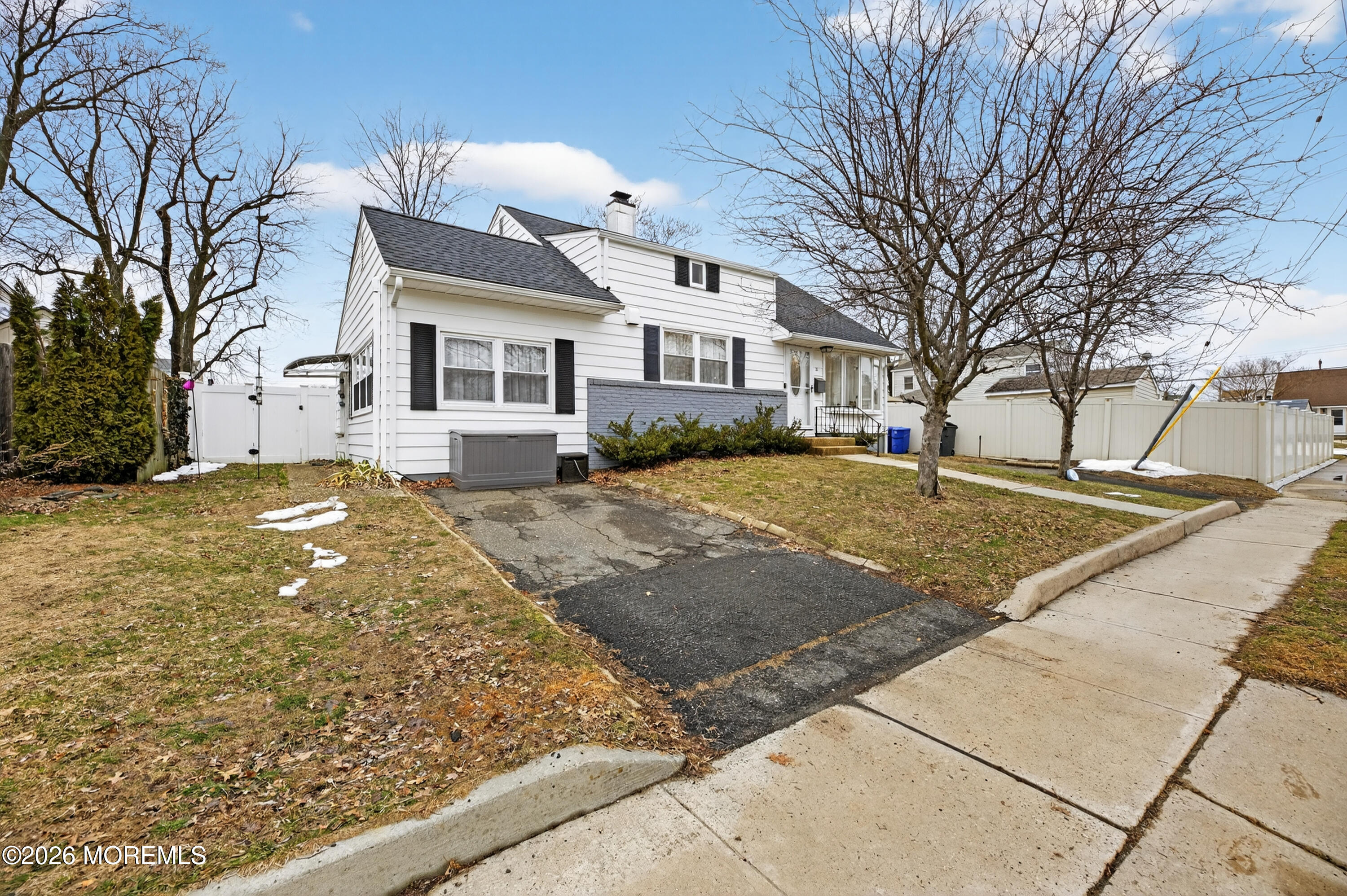 21 Anderson Street Union Beach, NJ 07735 - Photo 4 of 40 a view of a white house next to a yard with large trees