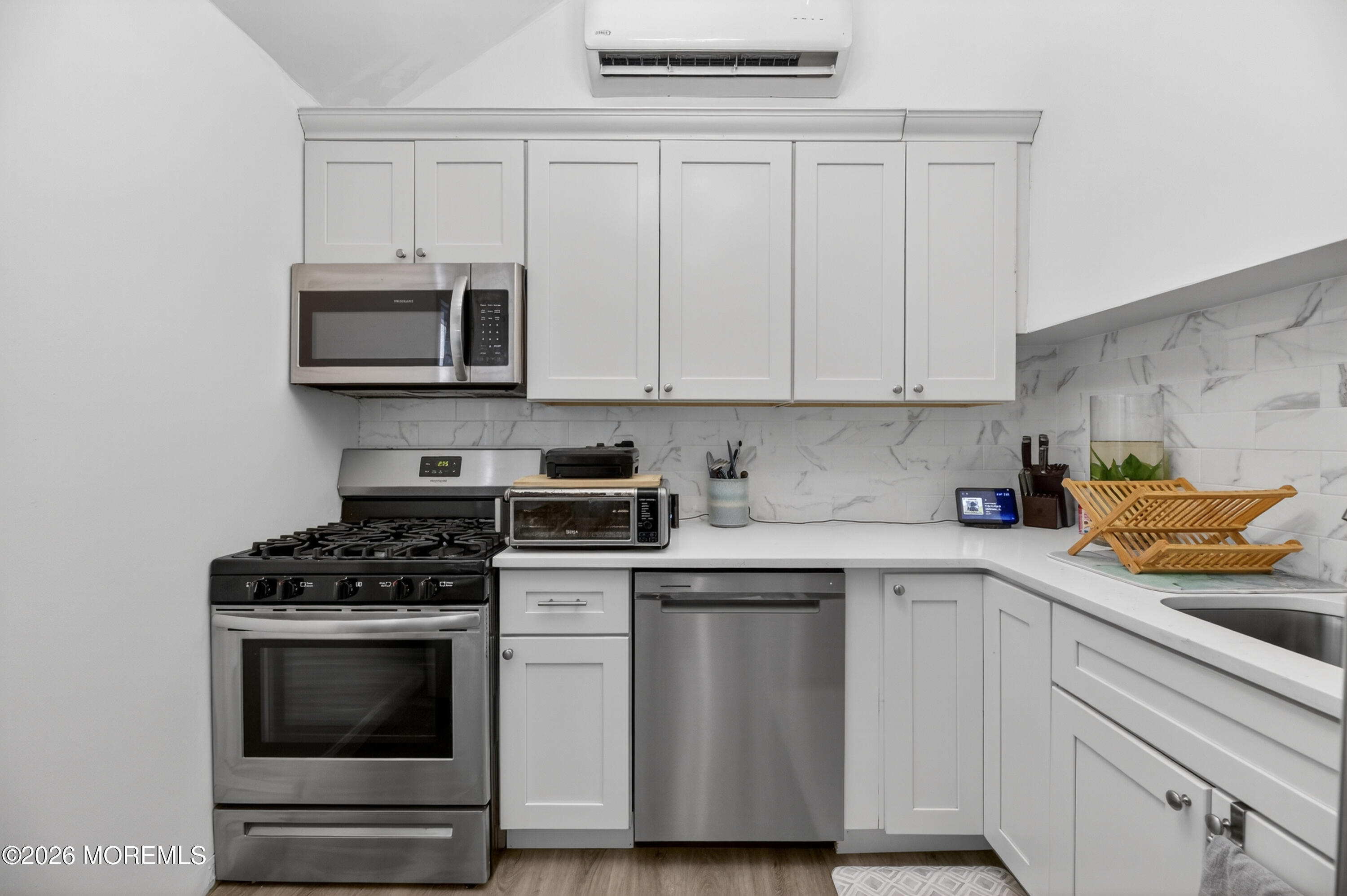 21 Anderson Street Union Beach, NJ 07735 - Photo 6 of 40 a kitchen with cabinets stainless steel appliances and wooden floor