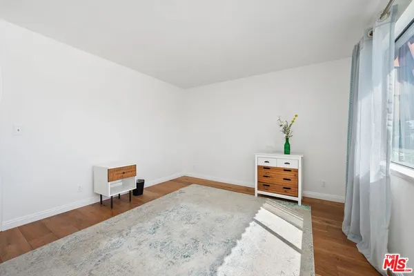 a bedroom with a bed and a book shelf