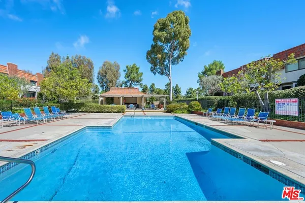 a swimming pool view with a outdoor seating