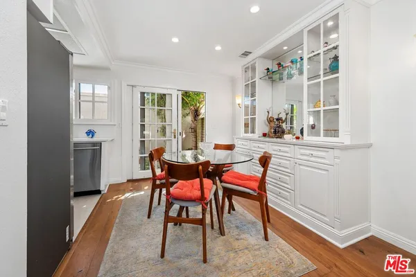 a dining room with furniture and wooden floor
