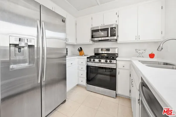 a kitchen with a refrigerator stove and microwave