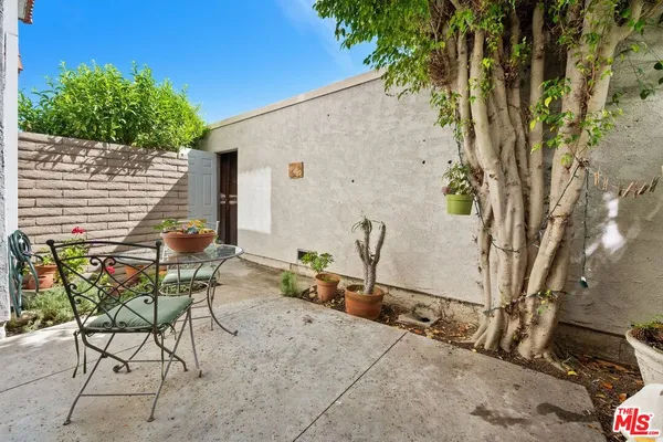 a backyard of a house with table and chairs