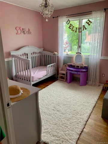 a bed sitting in a room next to a window
