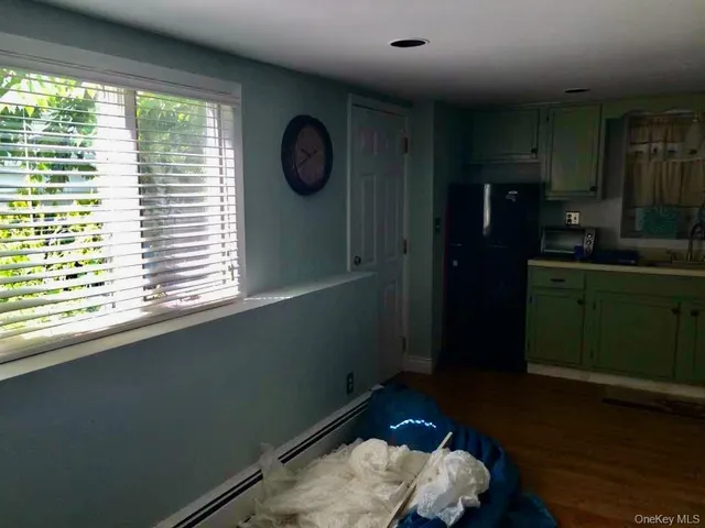 a bathroom with a window and a shower
