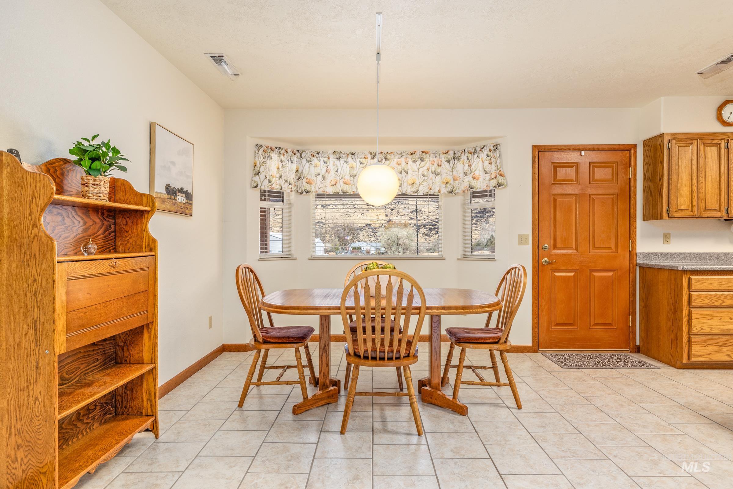 10514 Airpark Loop Road Melba, ID 83641 - Photo 19 of 47 Dining space with light tile patterned floors and baseboards