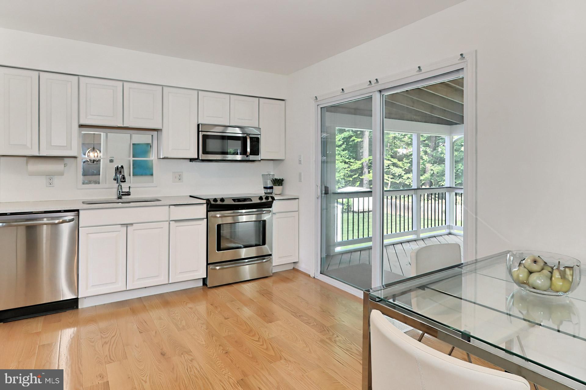 9110 Rockefeller Lane Springfield, VA 22153 - Photo 13 of 56 White kitchen cabinetry has pull-out shelves