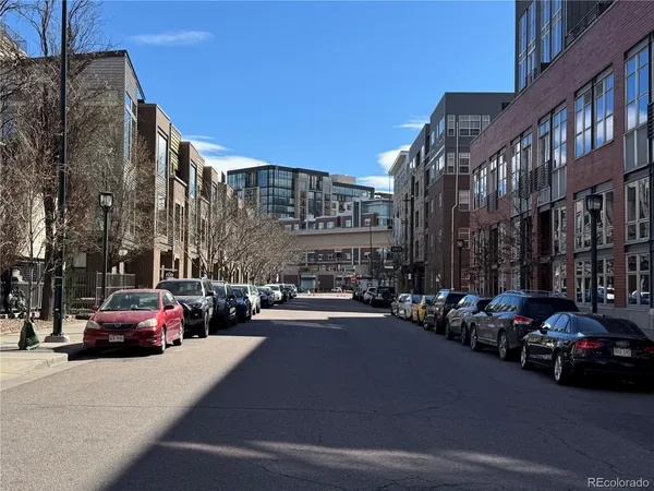 a city street with cars parked in front of it