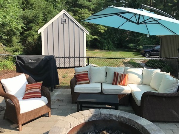 43 Mayflower Circle Hanover, MA 02339 - Photo 19 of 24 a outdoor living space with furniture and umbrella