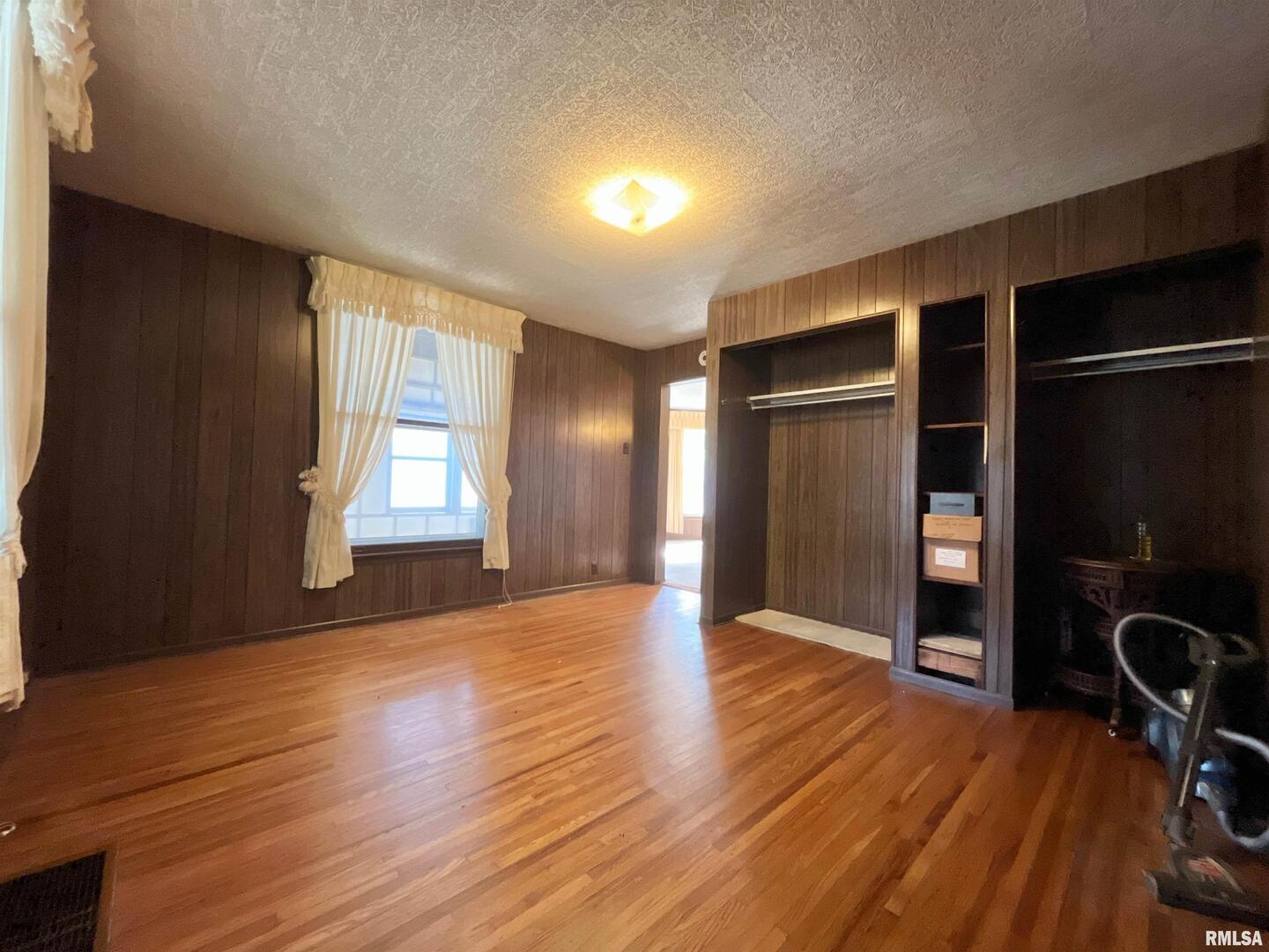 633 4th Avenue South Clinton, IA 52732 - Photo 8 of 34 a view of an empty room with a window and wooden floor