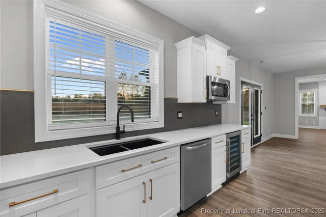 a kitchen with stainless steel appliances a sink stove and cabinets