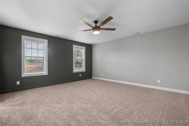 a view of a livingroom with a ceiling fan and window