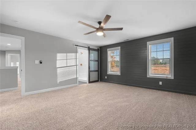 an empty room with closet and windows