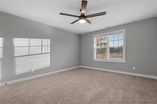 a view of a livingroom with a ceiling fan and window